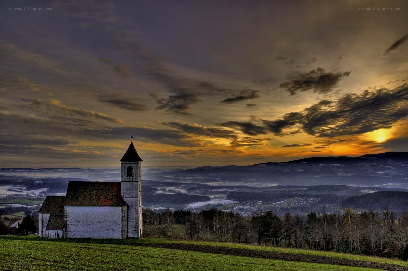 Church at sunset over valley