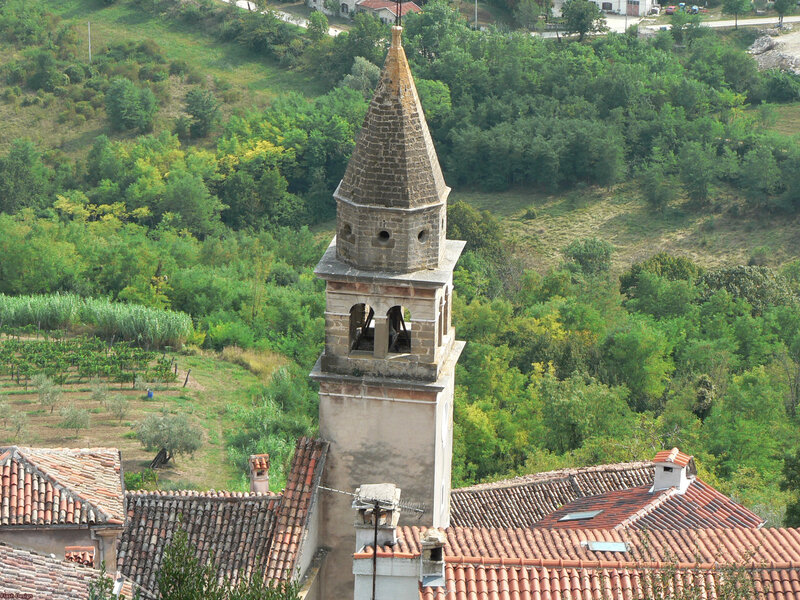 Church bell tower in a green valley