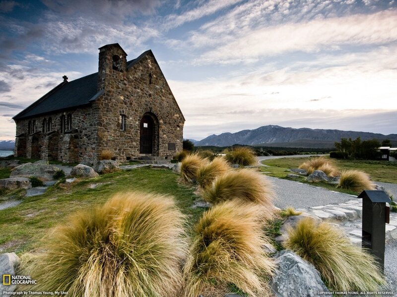 Church by a lake with mountains