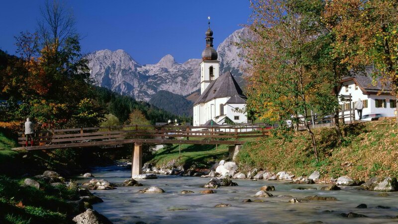 Church by a river in the Alps