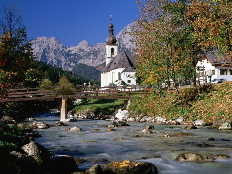 Church by a river in the Alps