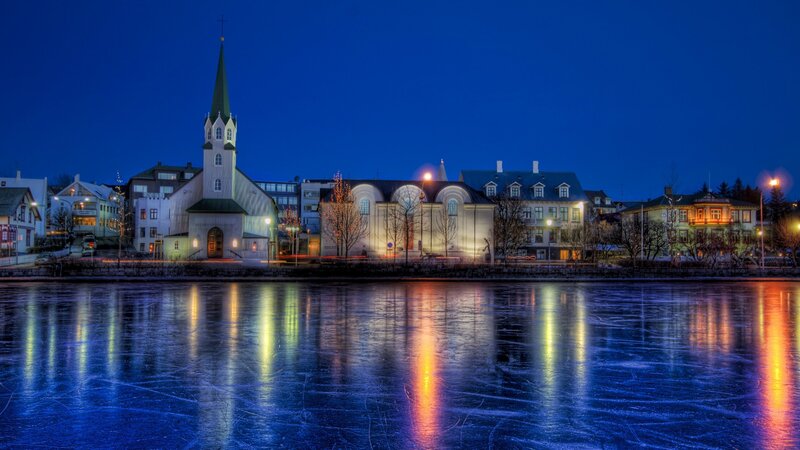 Church by the frozen lake at night