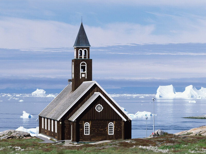 Church by the sea with icebergs