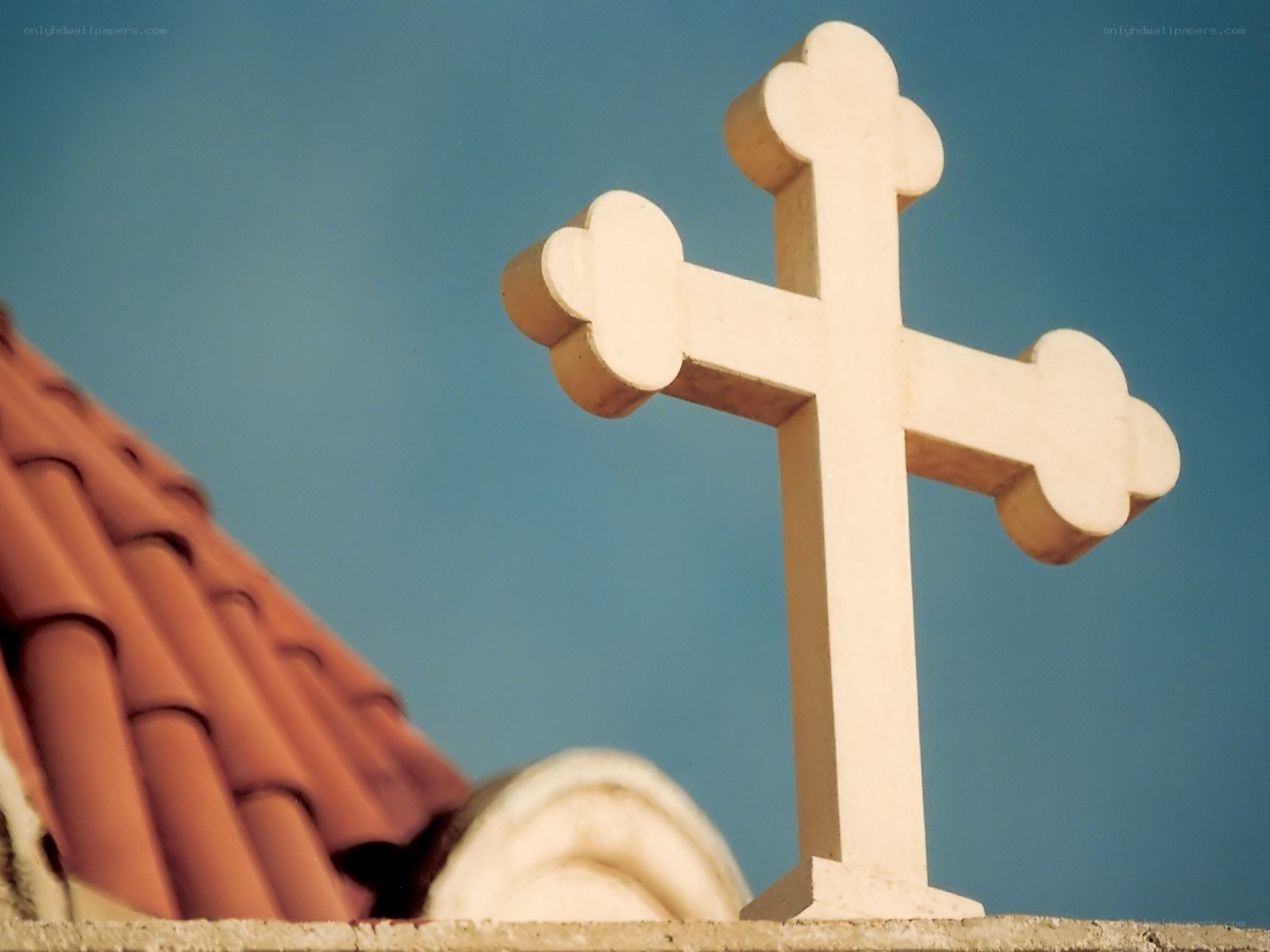 Church cross against blue sky