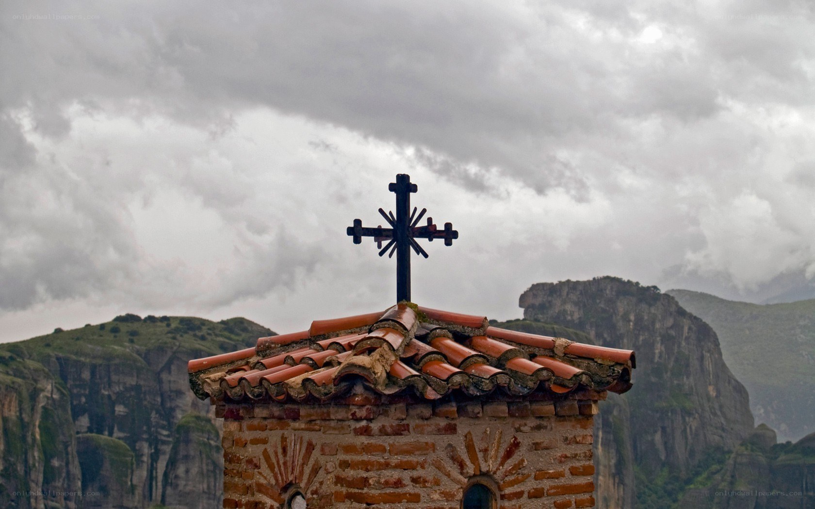 Church cross on mountain peak