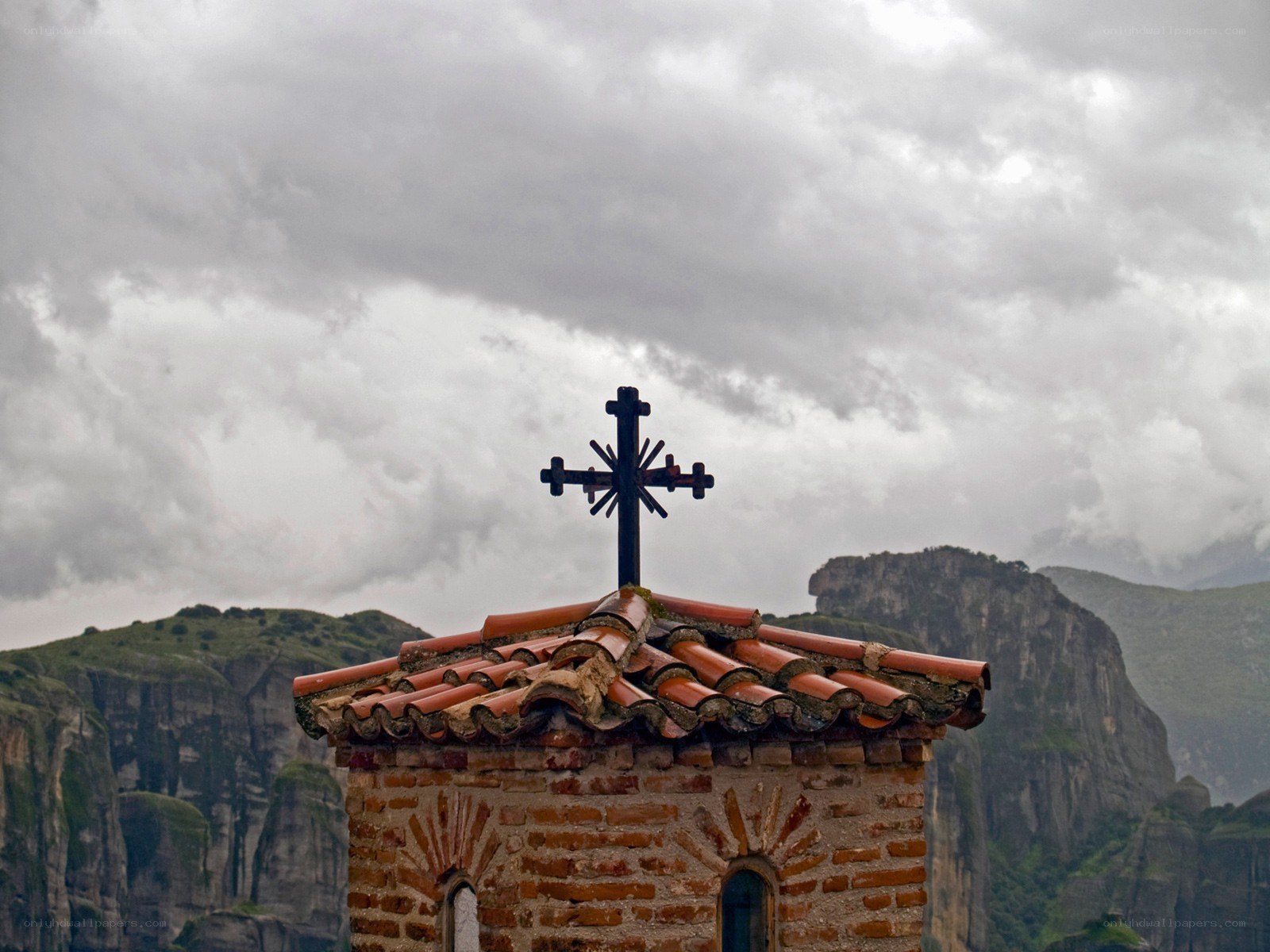 Church cross on mountain peak