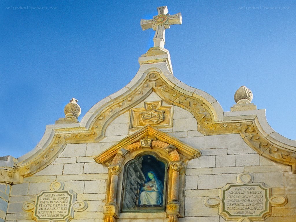 Church facade with cross and statue