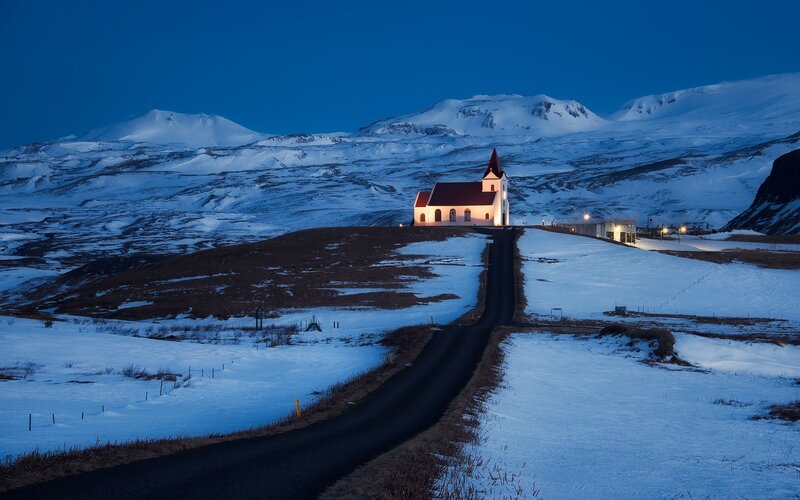 Church in snowy mountains at dusk