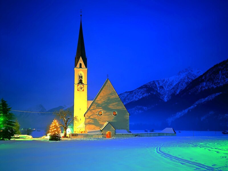 Church in snowy mountains at night