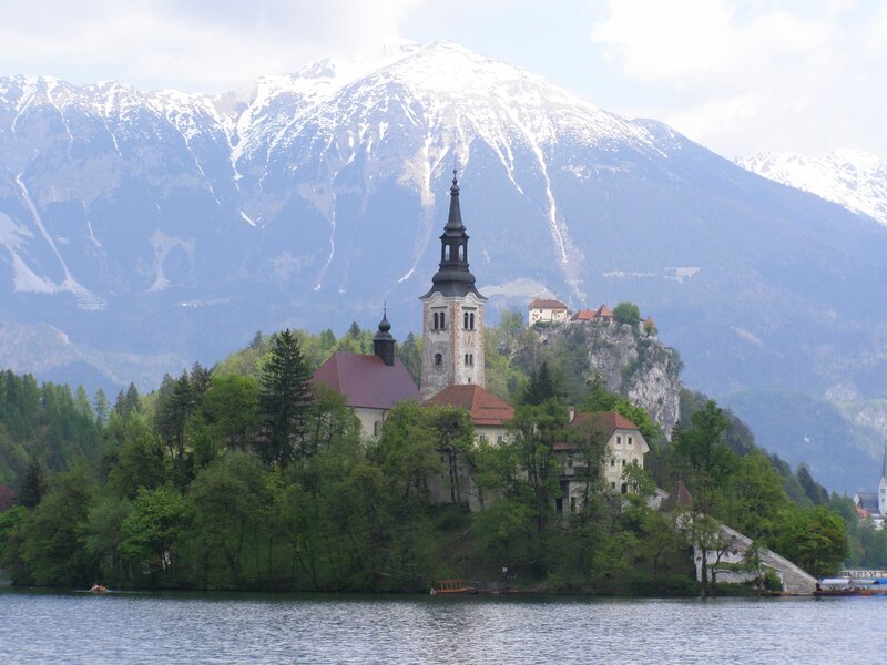 Church on a lake island with mountains