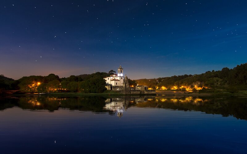 Church on a river island at night