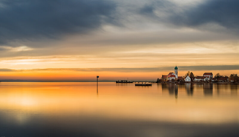 Church on Lake Island — Orange, Serene, Sunset