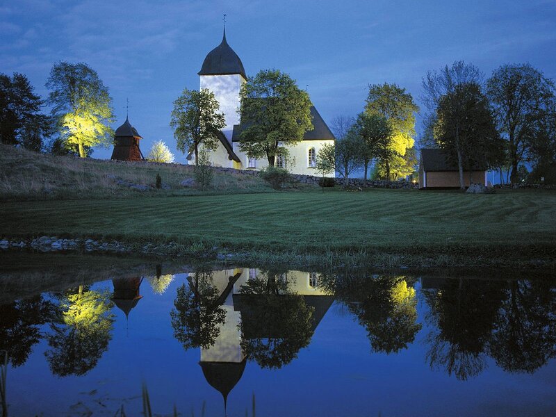 Church reflected in a pond at dusk
