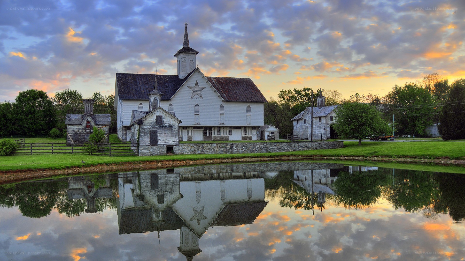 Church reflected in pond at sunset