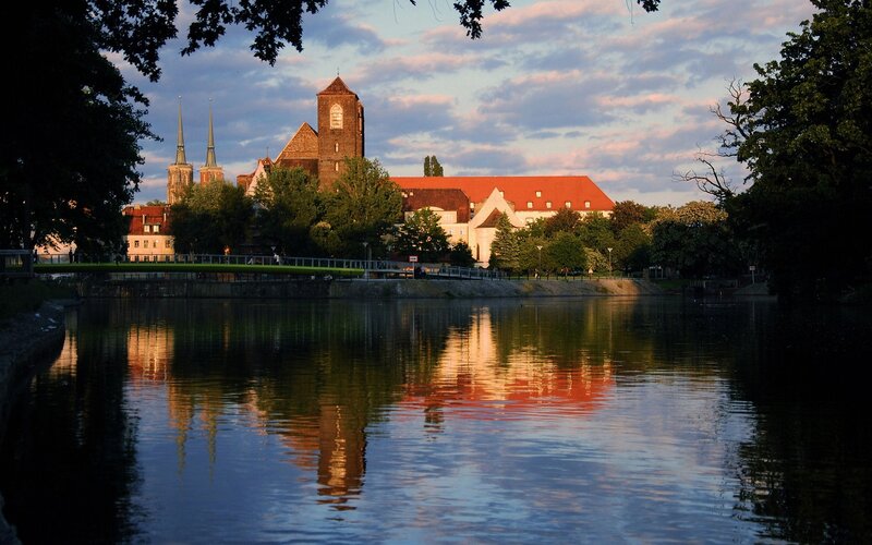 Church reflected in river at dusk