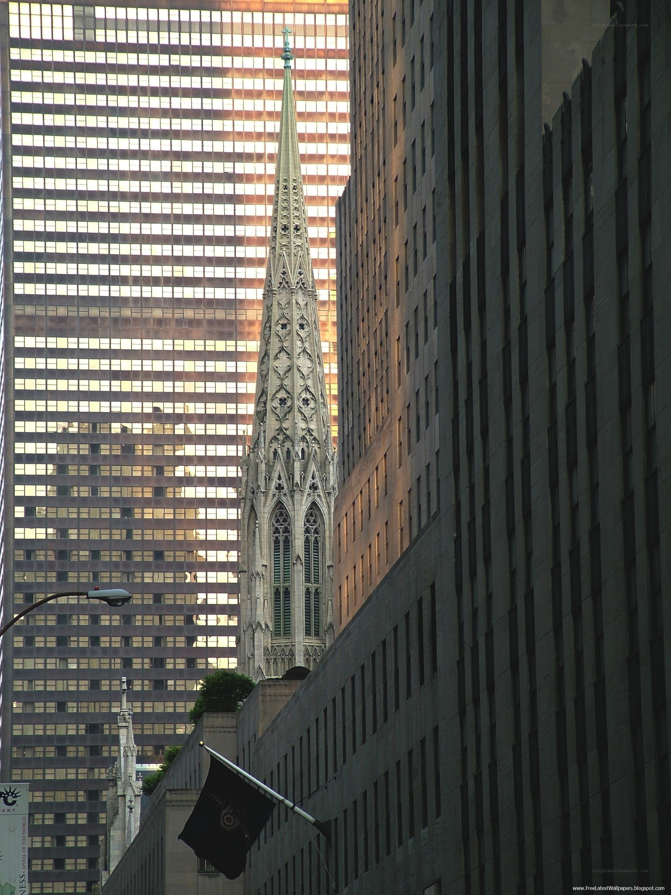 Church spire between skyscrapers