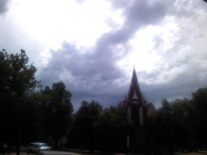 Church steeple under cloudy sky
