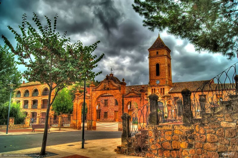 Church with bell tower under stormy sky