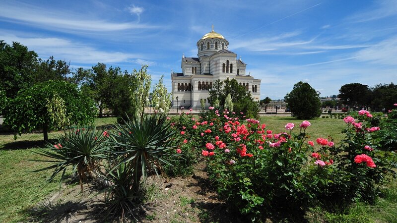 Church with golden dome and rose garden