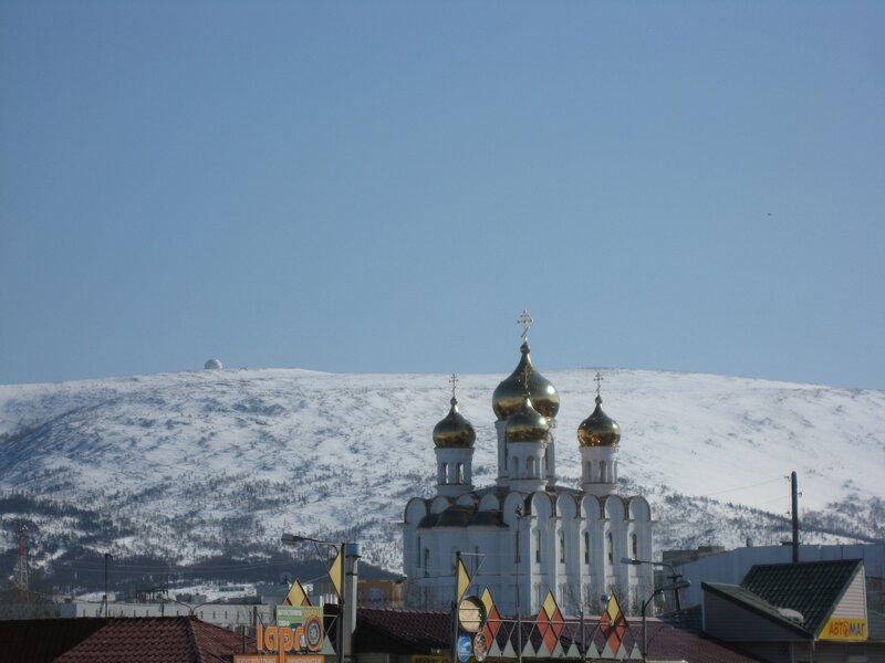 Church with golden domes in snowy landscape