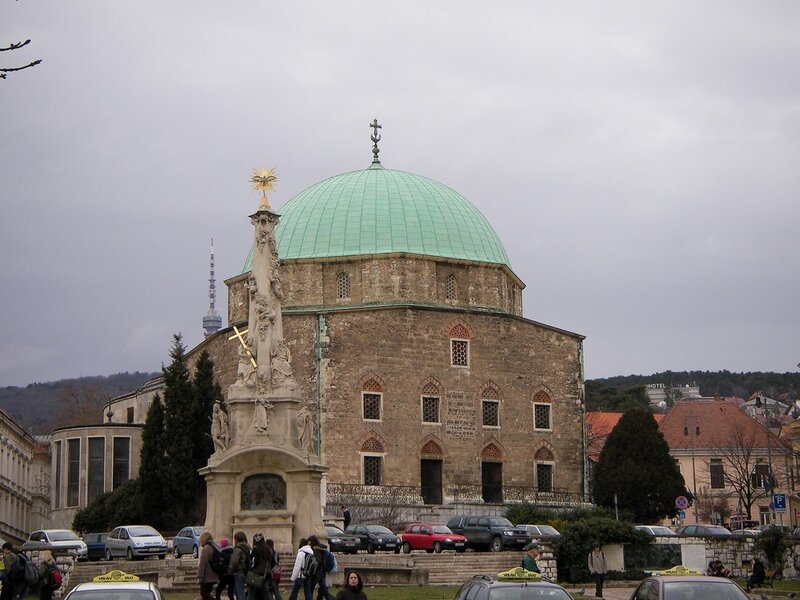 Church with green dome and monument
