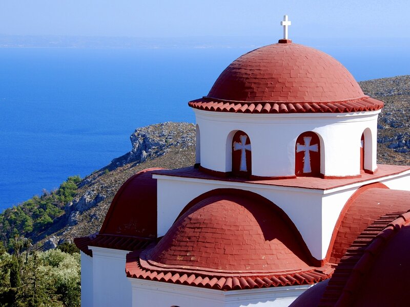 Church with red domes by the sea