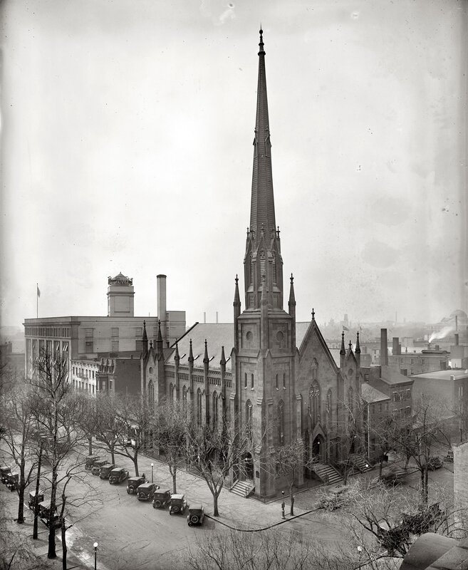 Church with tall spire in city