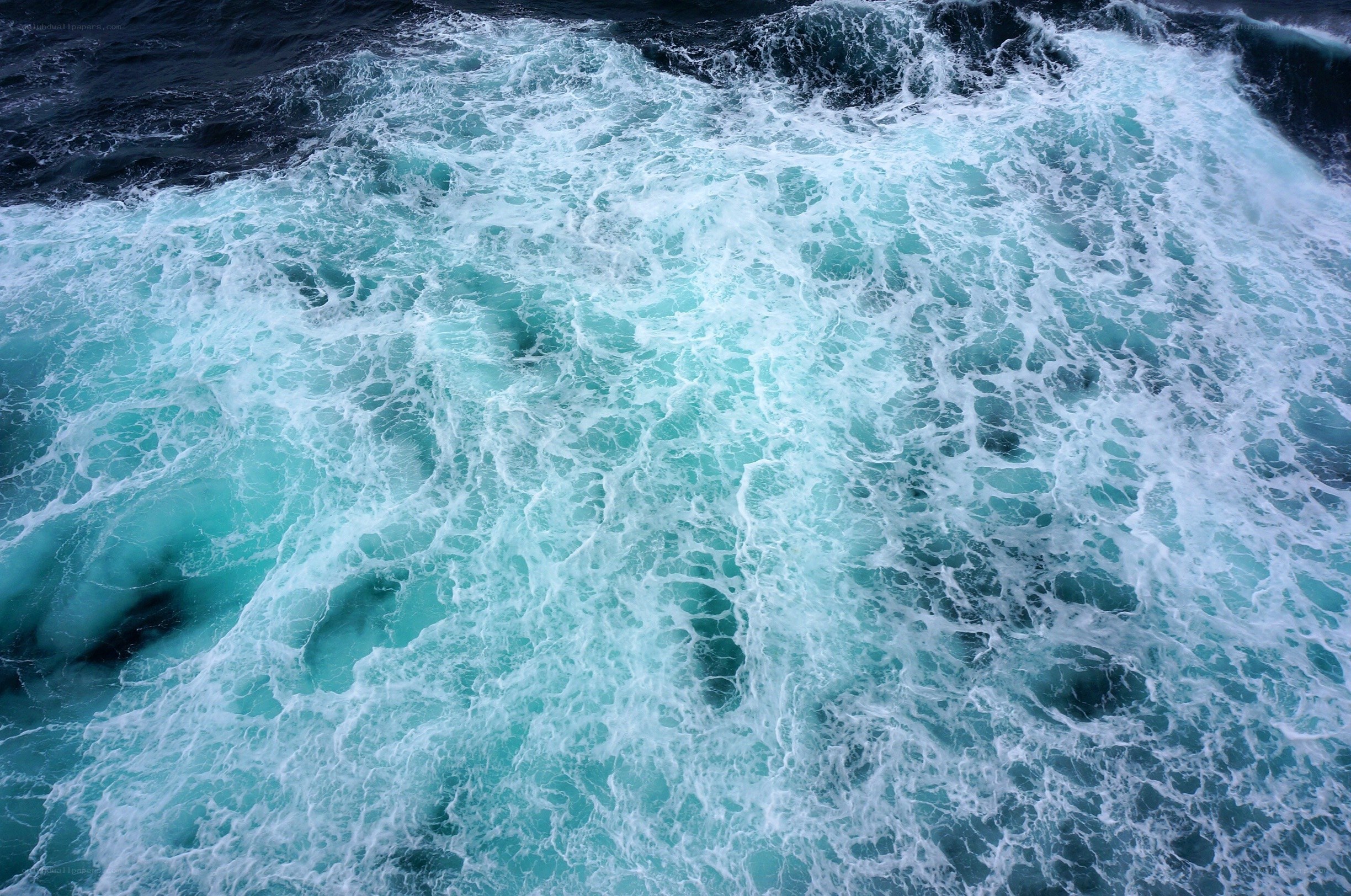 Churning ocean waves from above