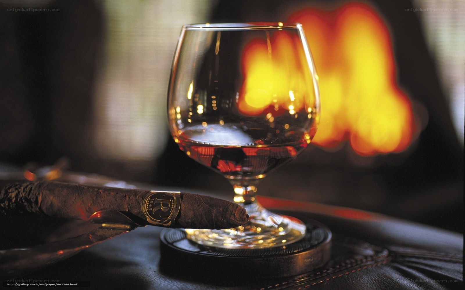 Cigar and brandy by fireplace