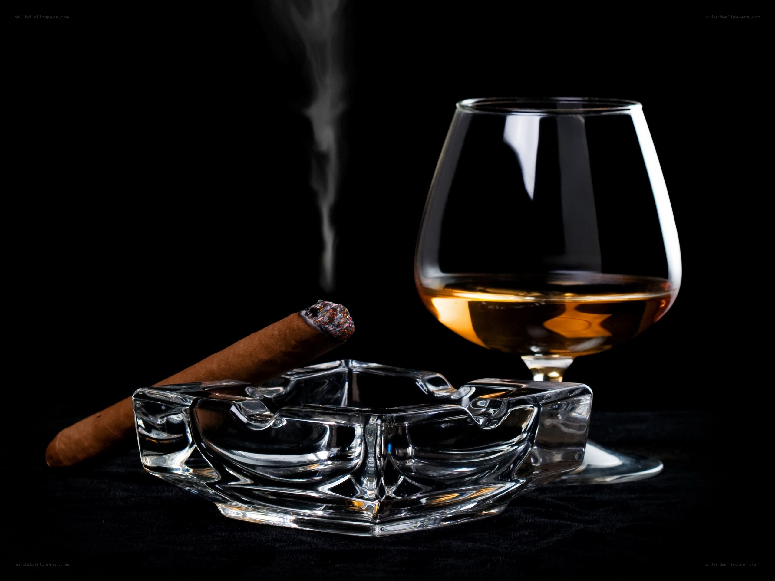 Cigar and brandy on black