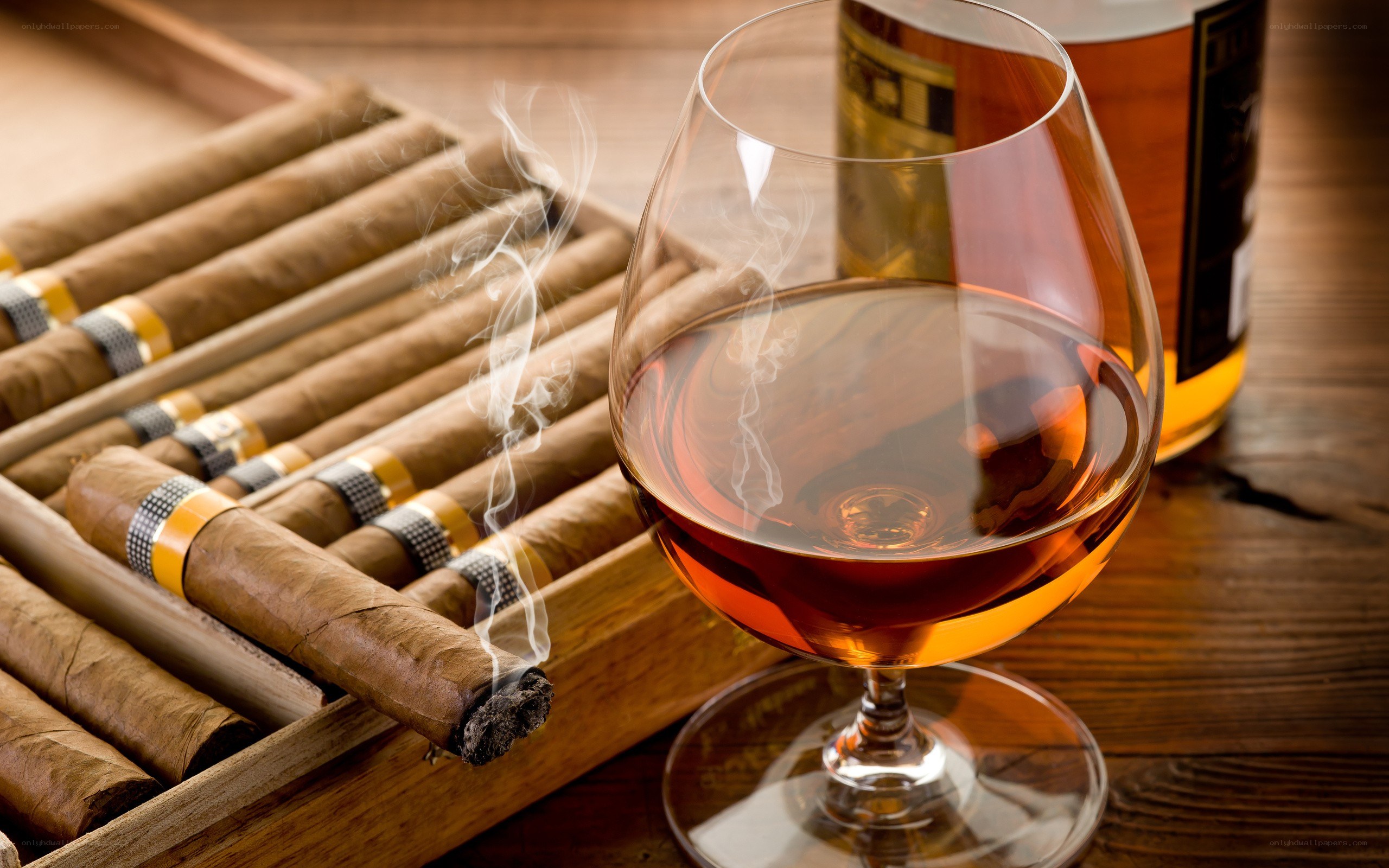 Cigar and brandy on wooden table
