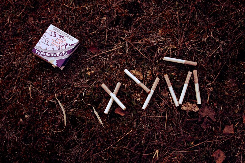 Cigarette Butts on Ground — Brown, Somber