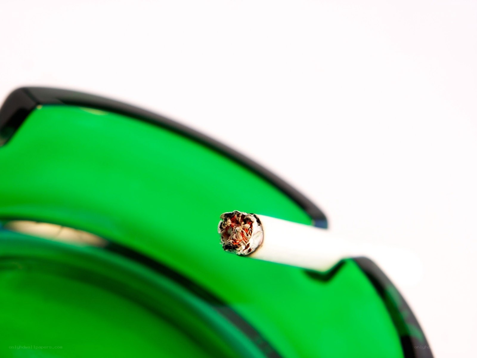 Cigarette in green ashtray