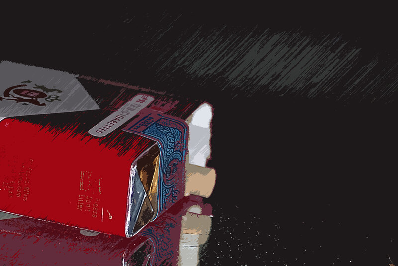 Cigarette packs on dark surface