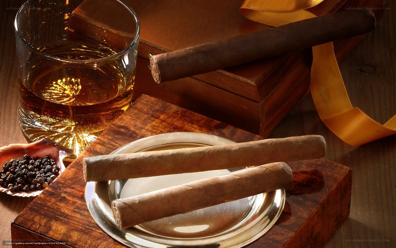 Cigars and whiskey on wood