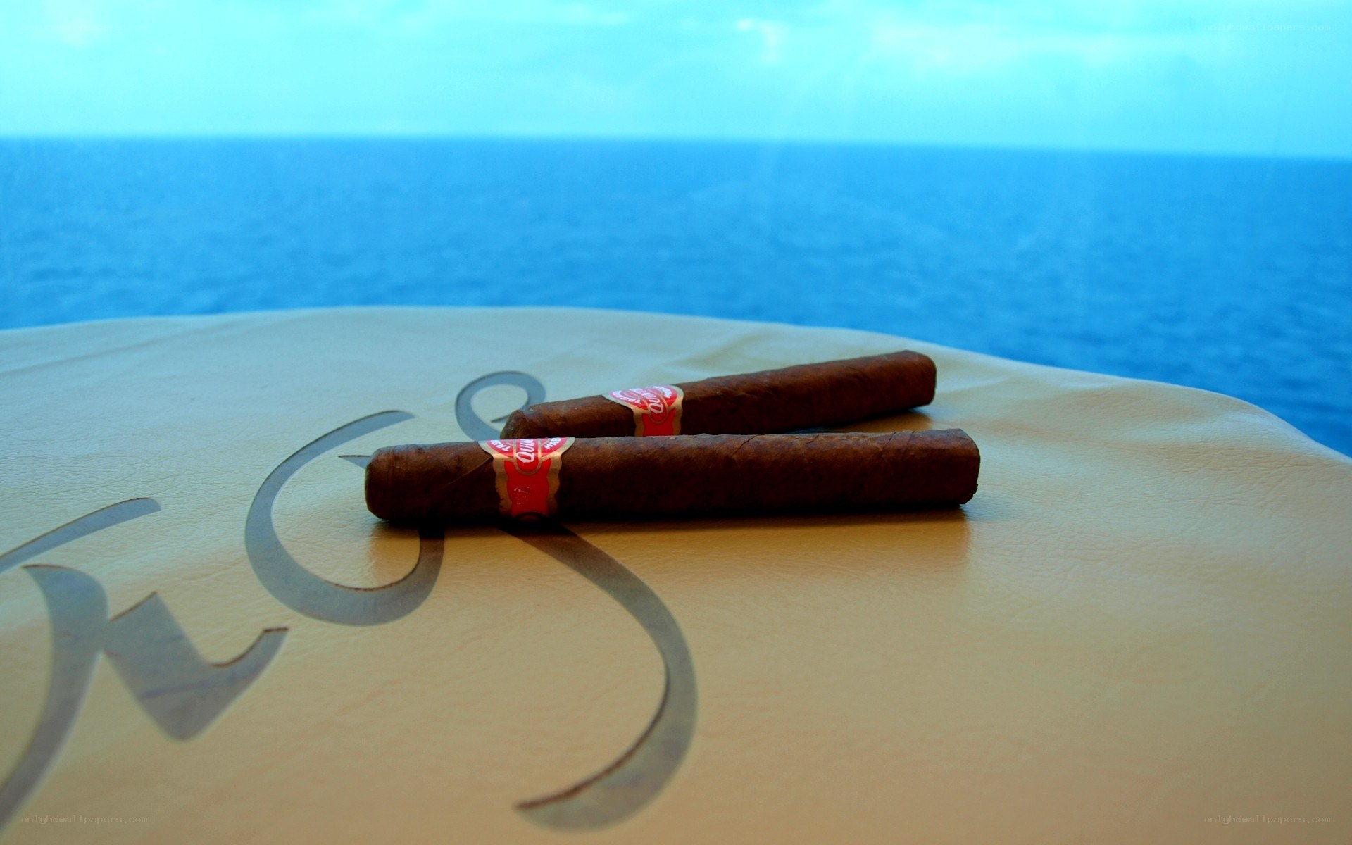 Cigars on a table by the sea