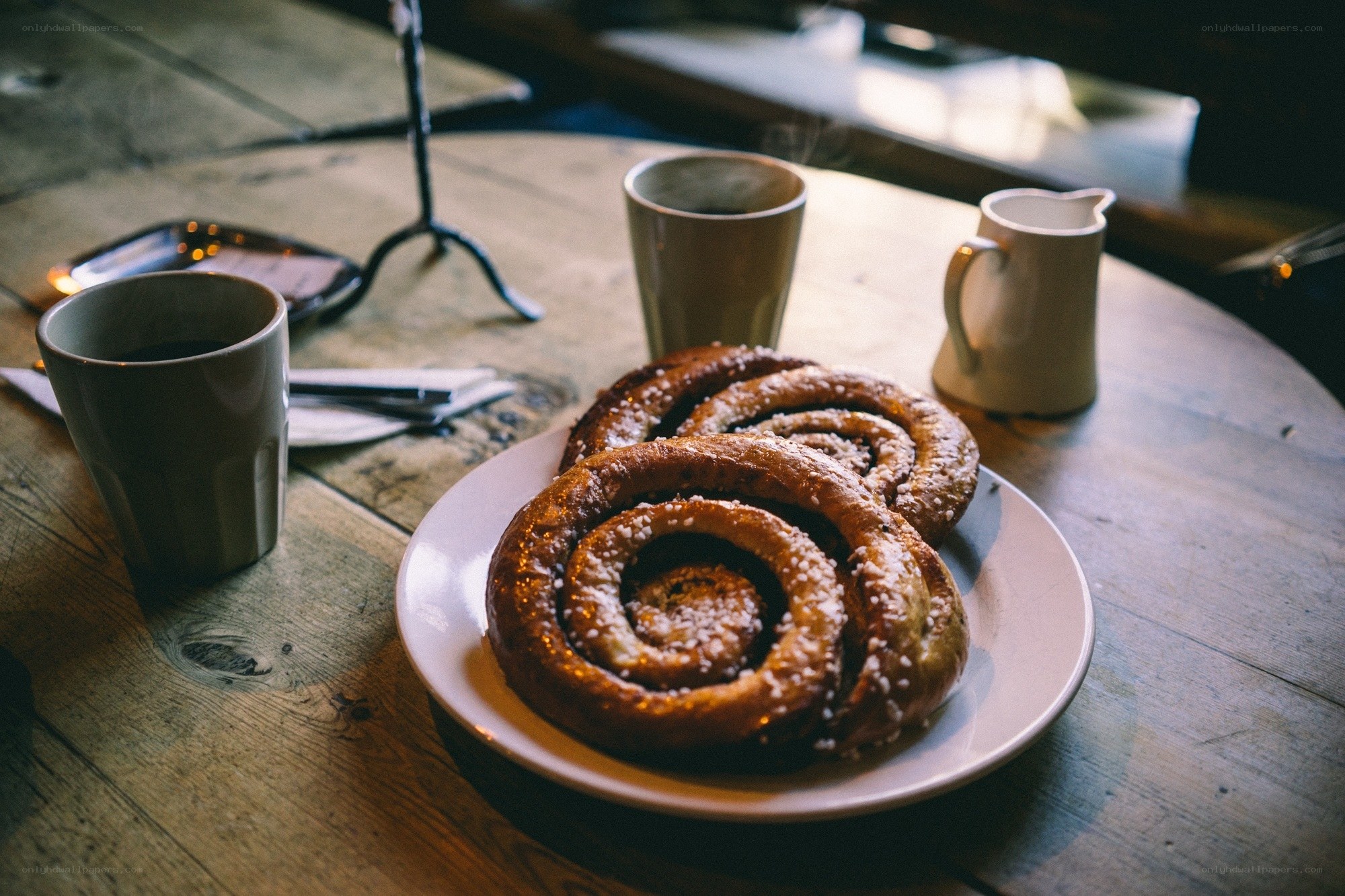 Cinnamon buns and coffee on a wooden table