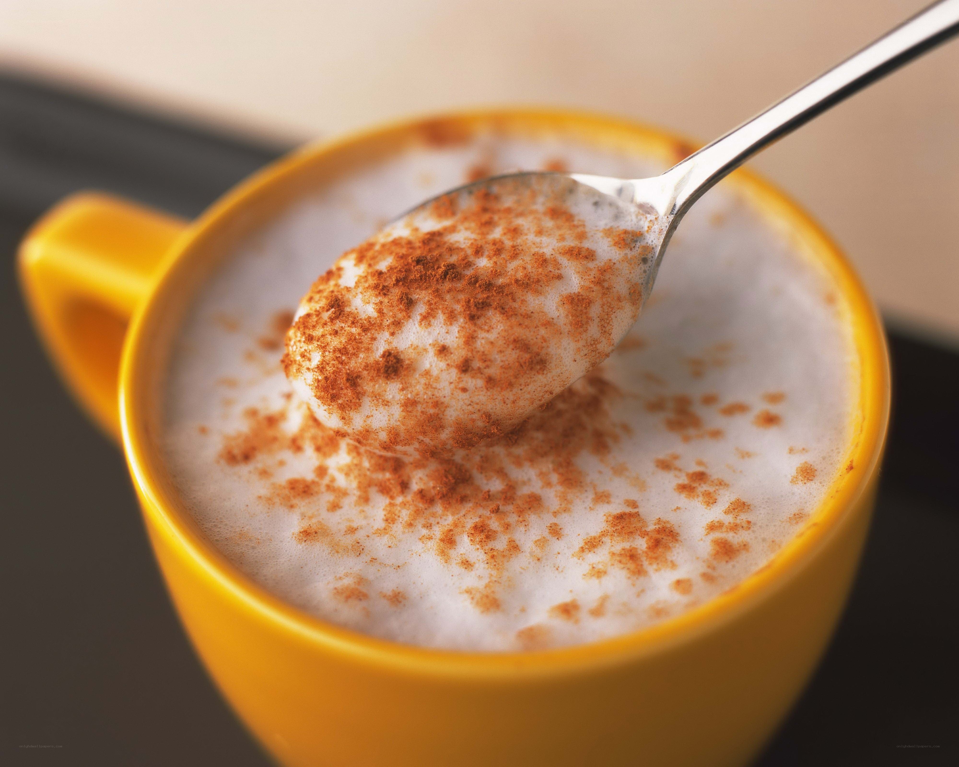 cinnamon latte in yellow cup