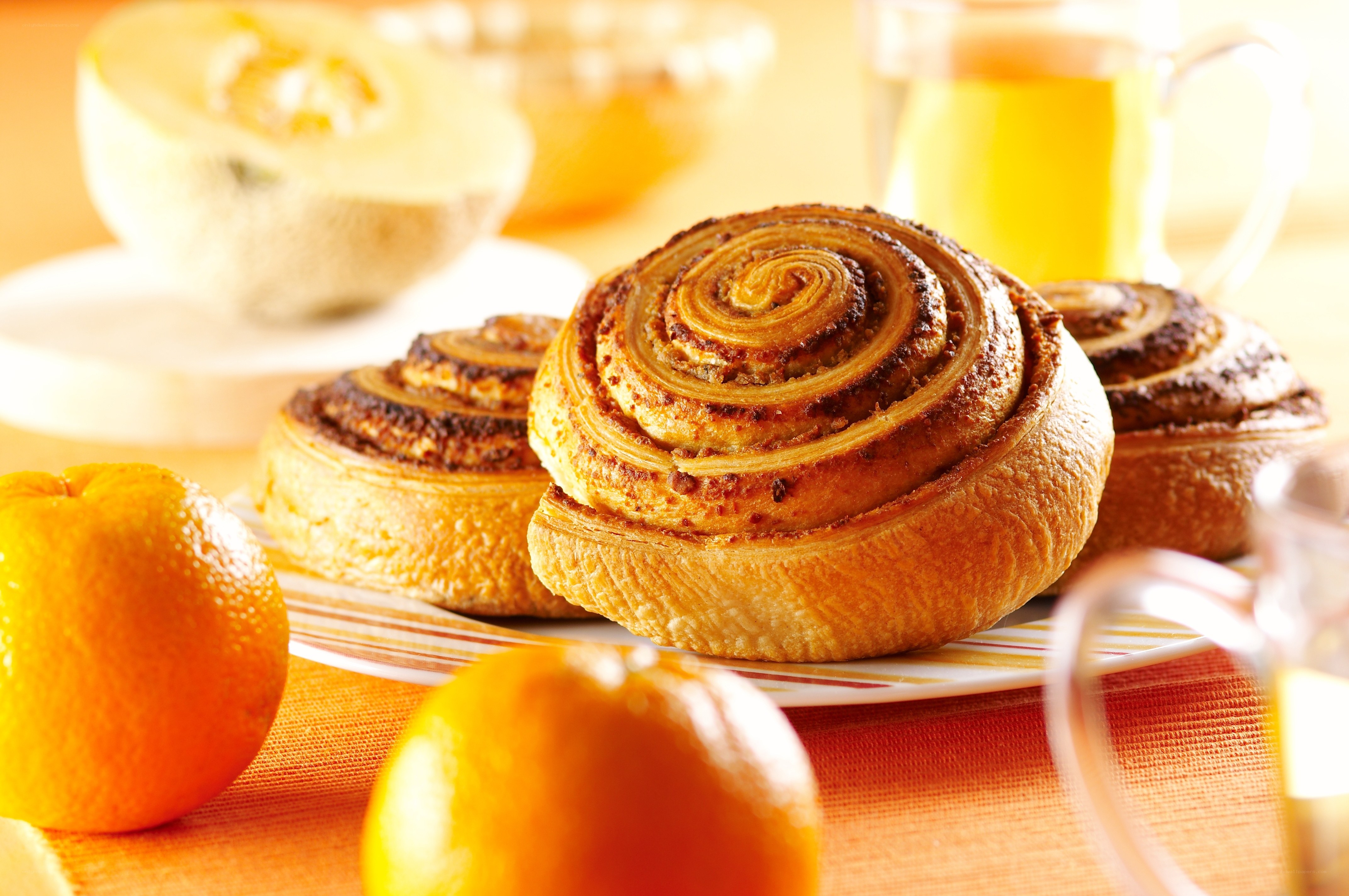 Cinnamon rolls with oranges and melon