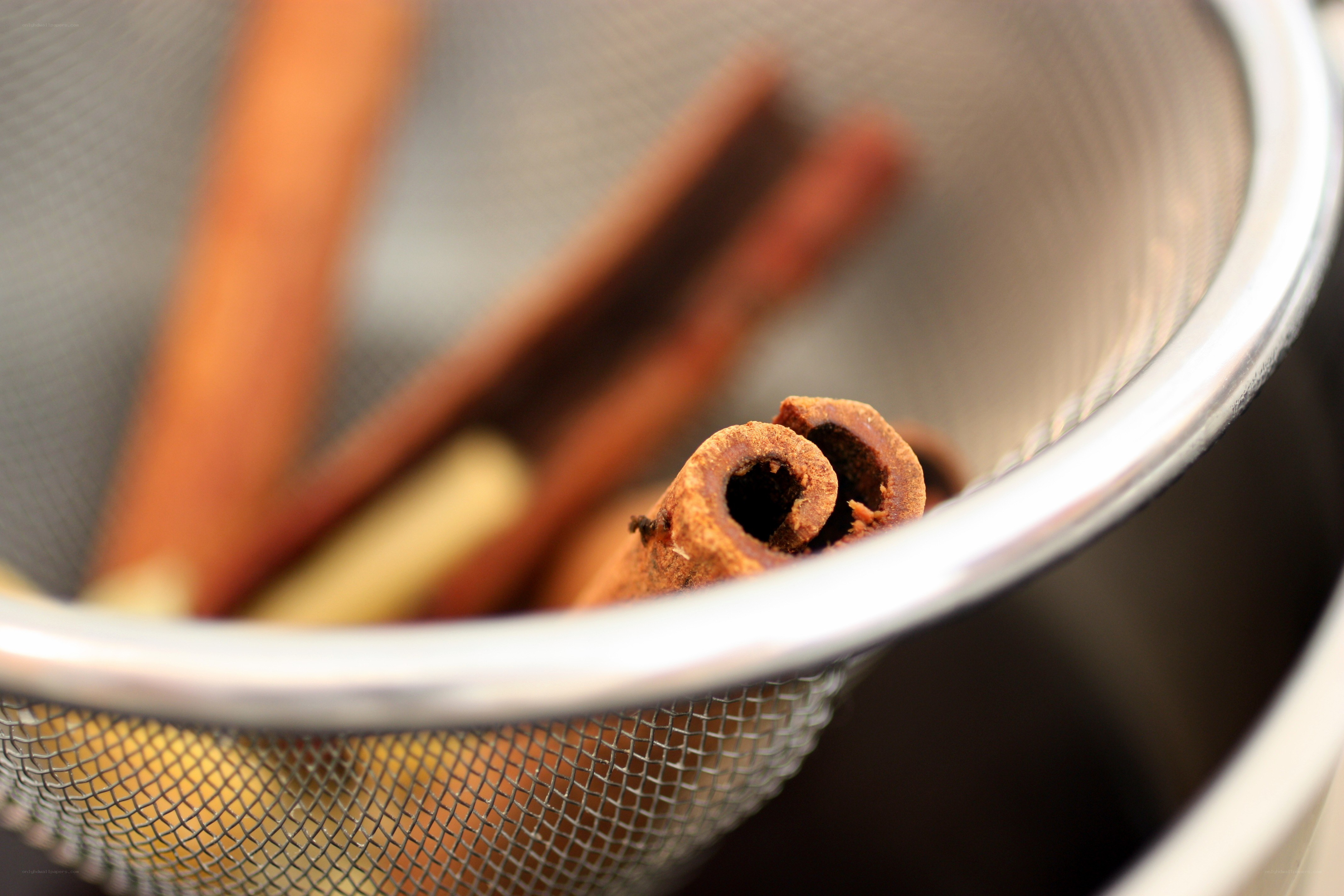 cinnamon sticks in a strainer