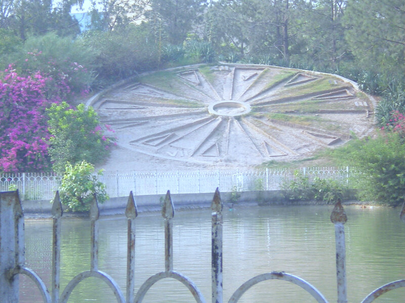 circular garden design by pond