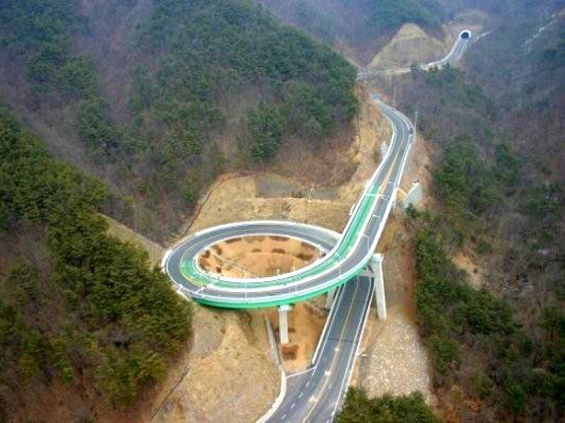 Circular highway bridge in mountains