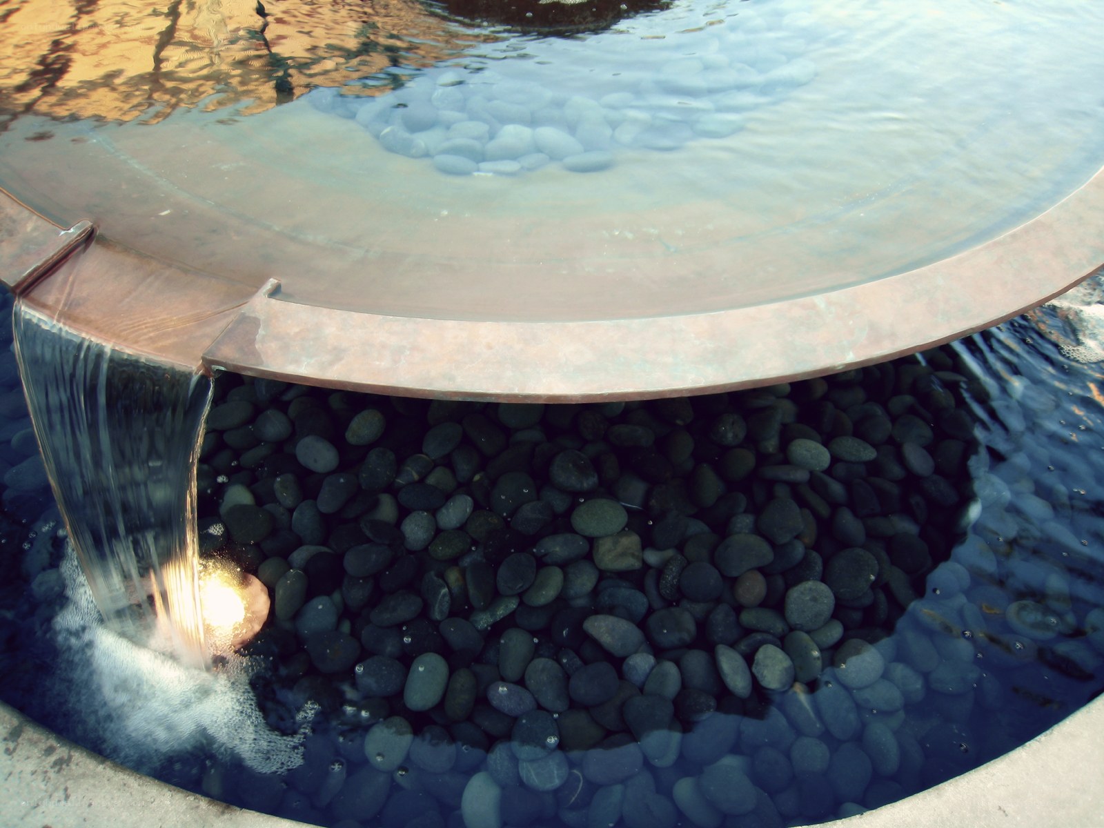 circular water feature with pebbles