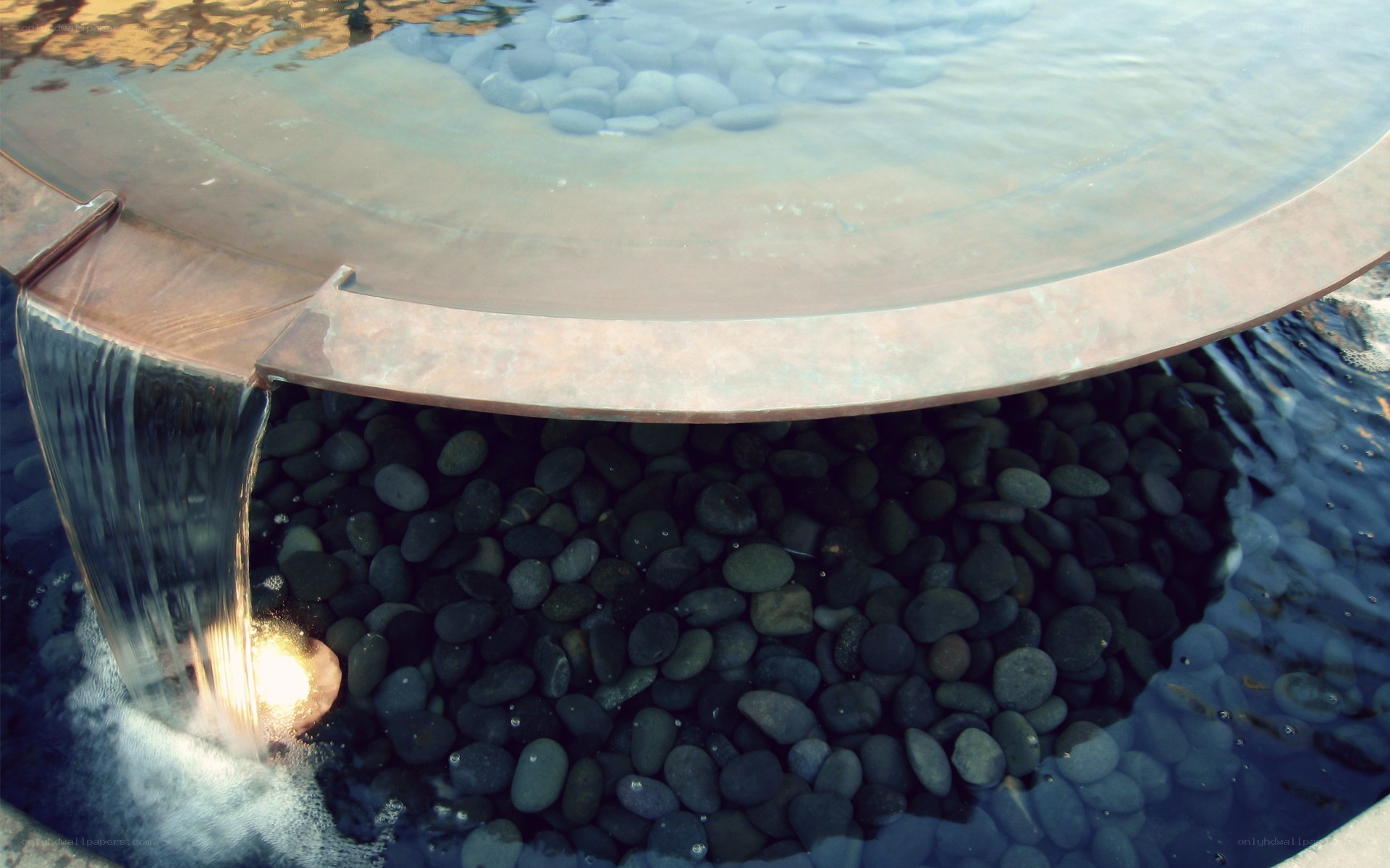 circular water feature with pebbles