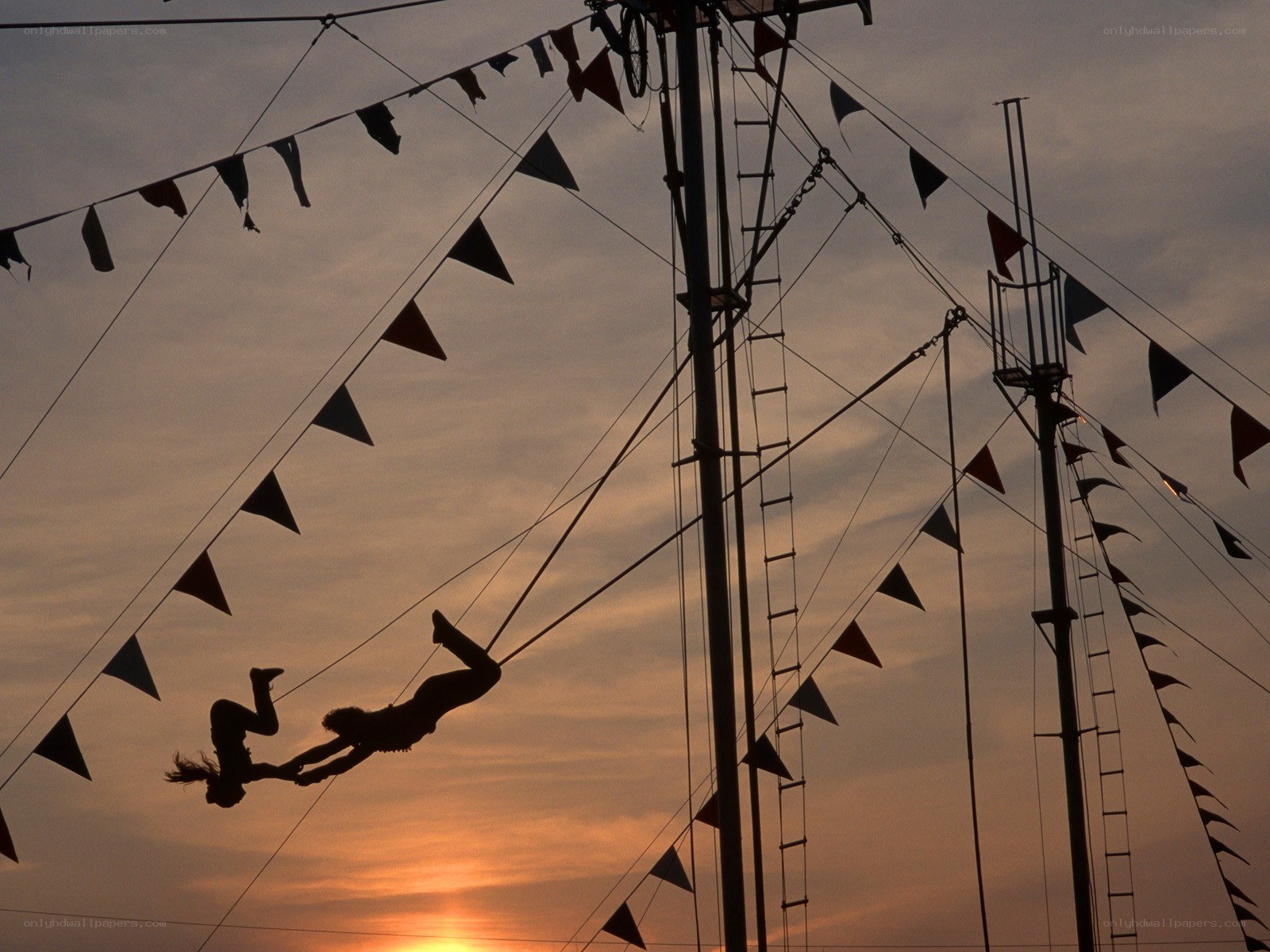 Circus acrobats at sunset