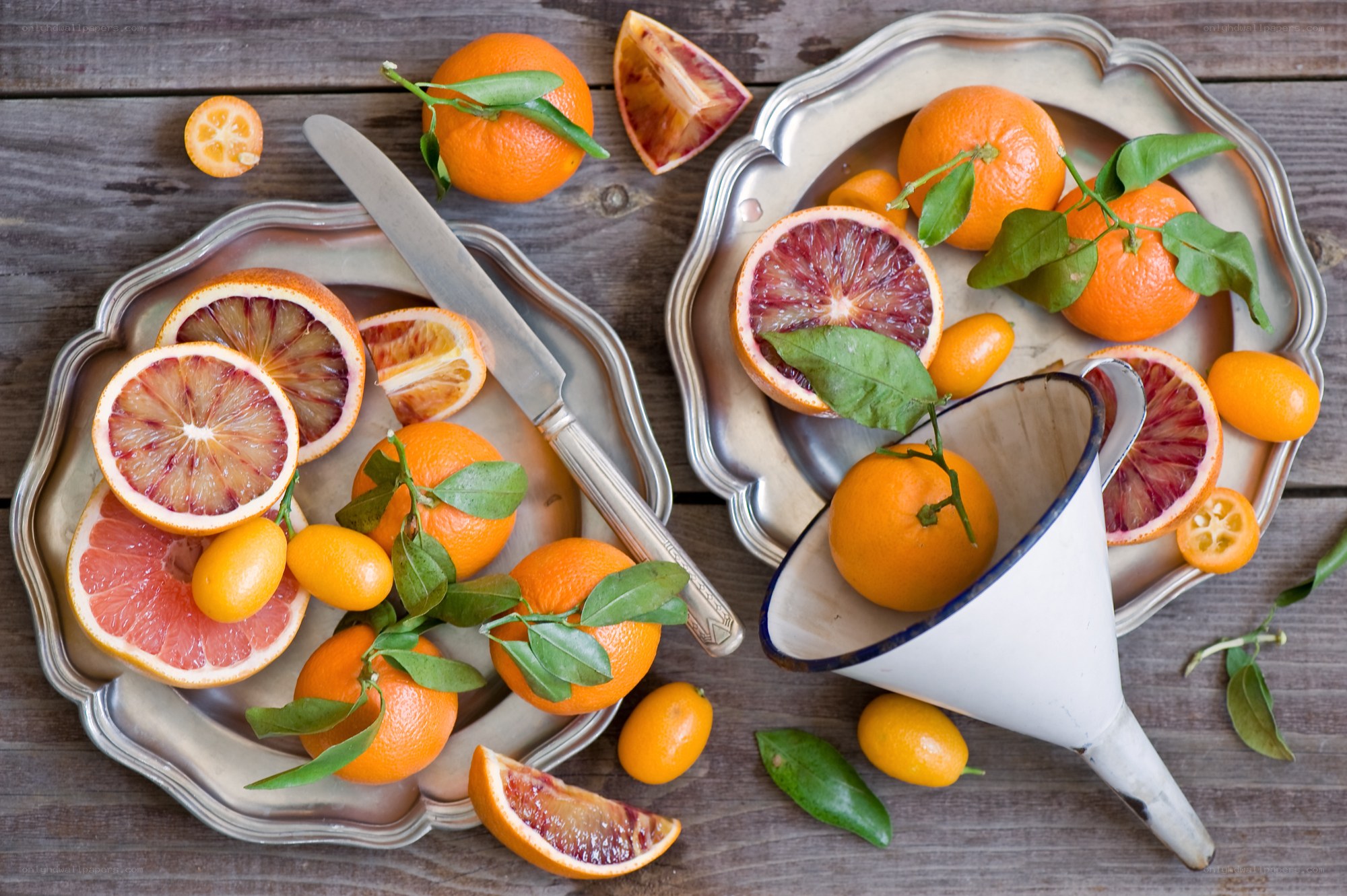 Citrus fruits on silver platters