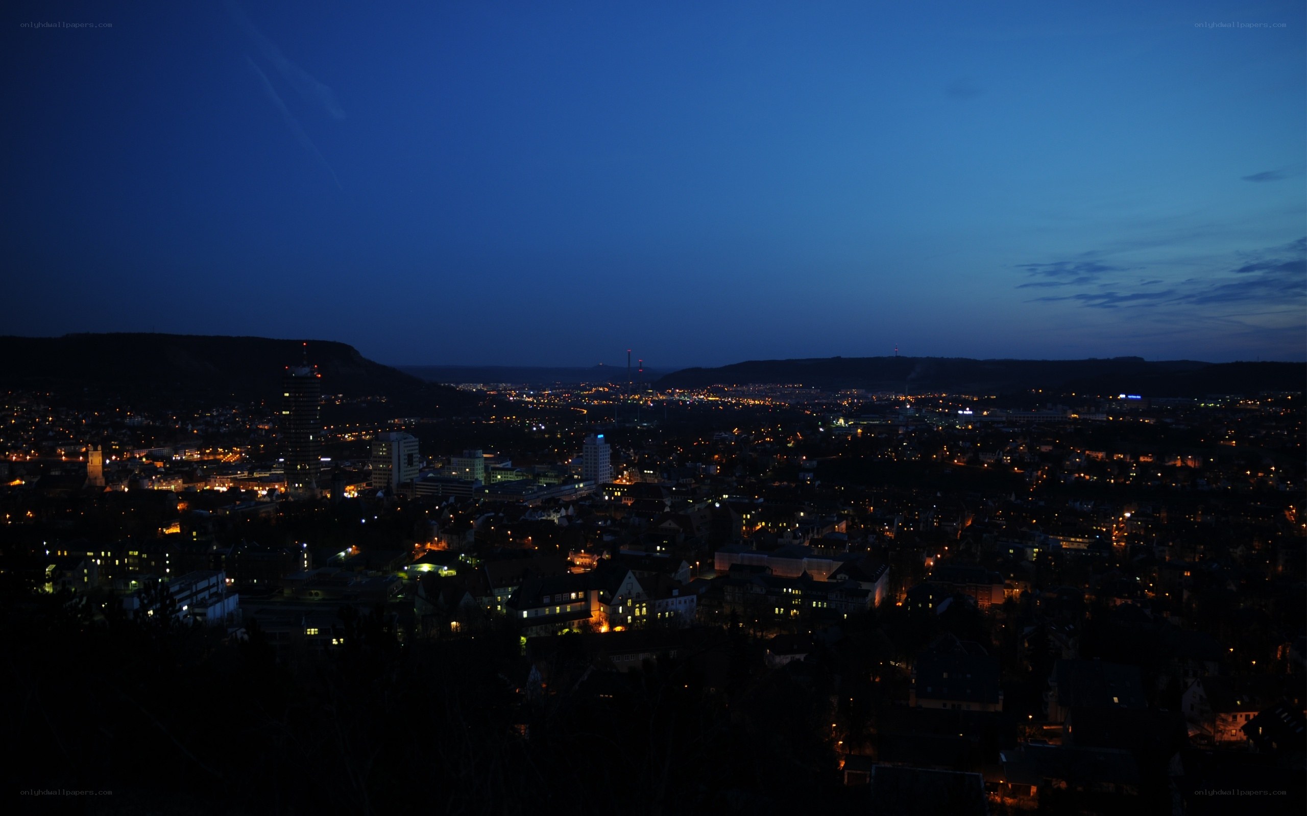 city at dusk from a hill