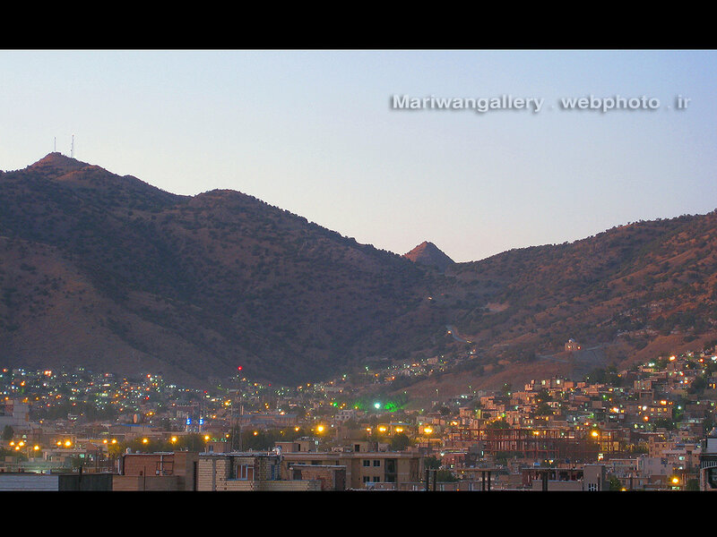 City at dusk in mountainous region