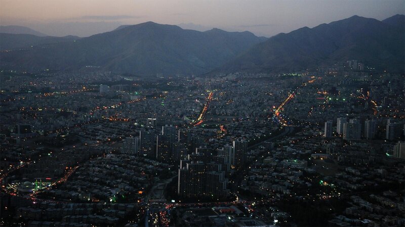 city at dusk with mountains
