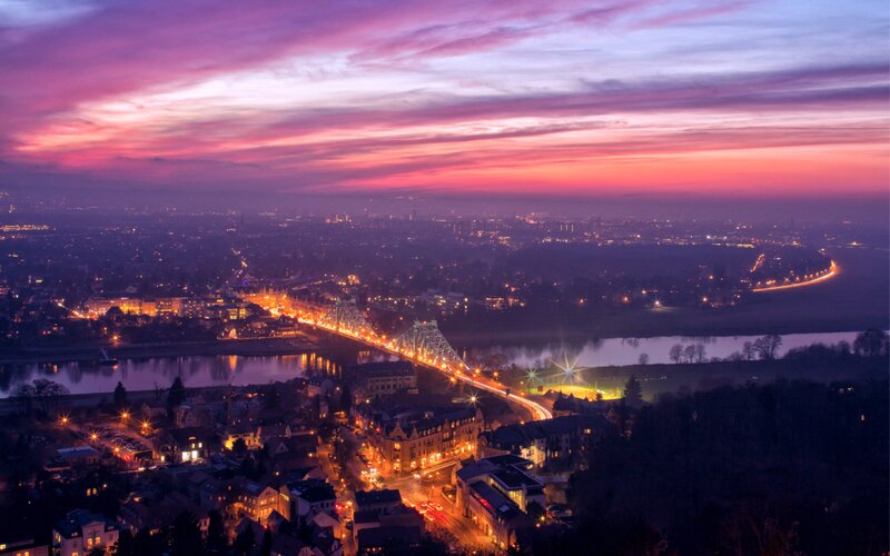 City at dusk with river and bridge